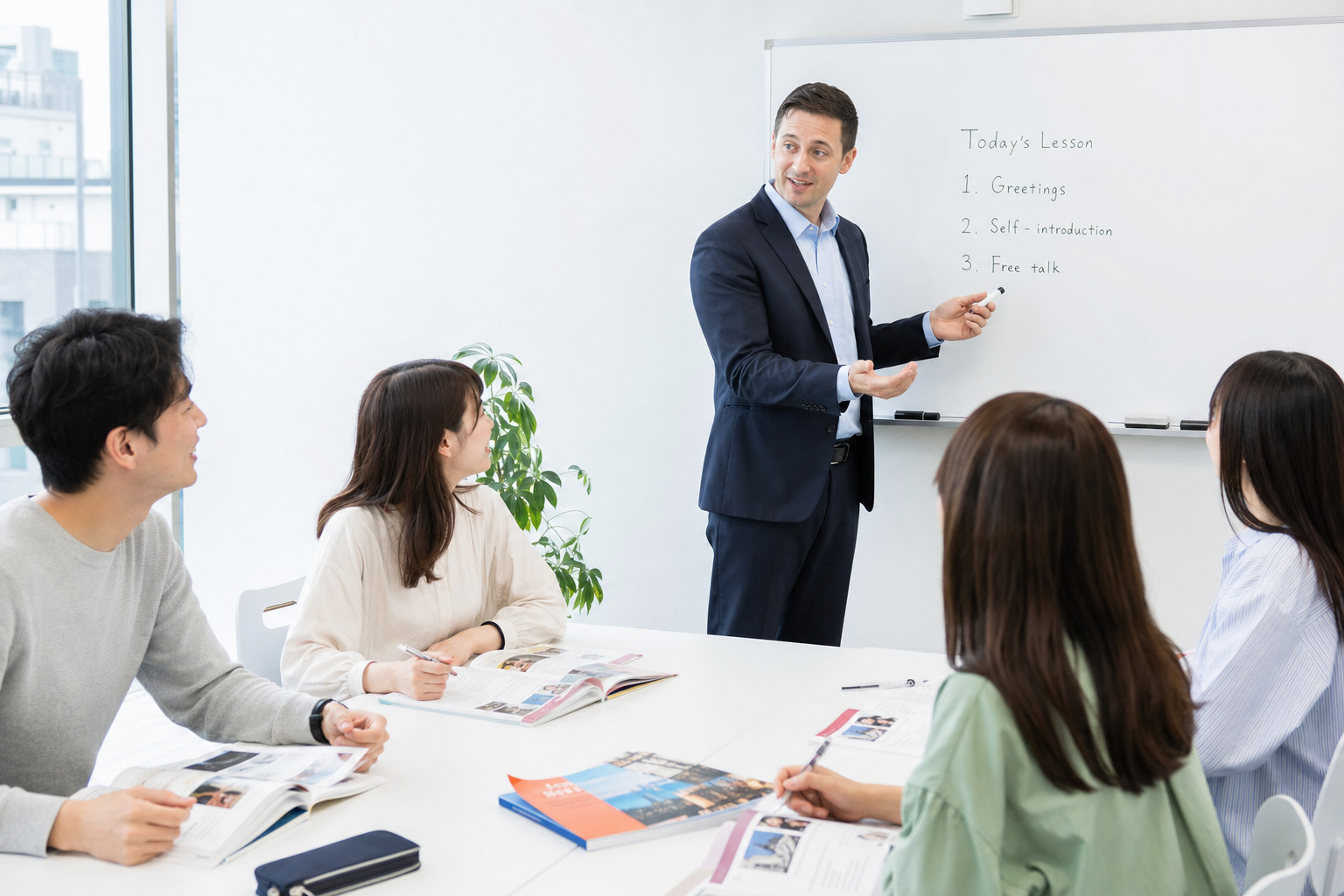 明るい教室で受講者と会話する英会話講師